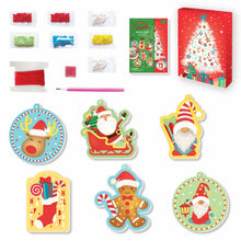 Load image into Gallery viewer, Image of the materials inside of the Totally Santa Diamond Art Ornaments &amp; Gift Tags which Includes: 6 artboard cards, 7 bags of assorted diamond stones, 1 stone pick pen tool, 1 square of pen wax, decorative red ribbon and instructions, all in a keepsake storage box made from recycled cardboard.
