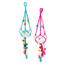 Load image into Gallery viewer, Lifestyle image of two completed Macrame Plant Hangers. One is blue string and the other is pink string. 
