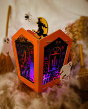 Load image into Gallery viewer, Image of the completed haunted house lantern scratch art surrounded by spooky smoke. 
