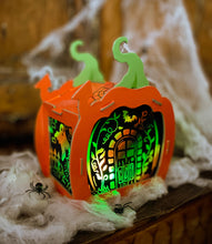 Load image into Gallery viewer, Image of the completed Totally Spooky Pumpkin Lantern Scratch Art that is glowing green. 
