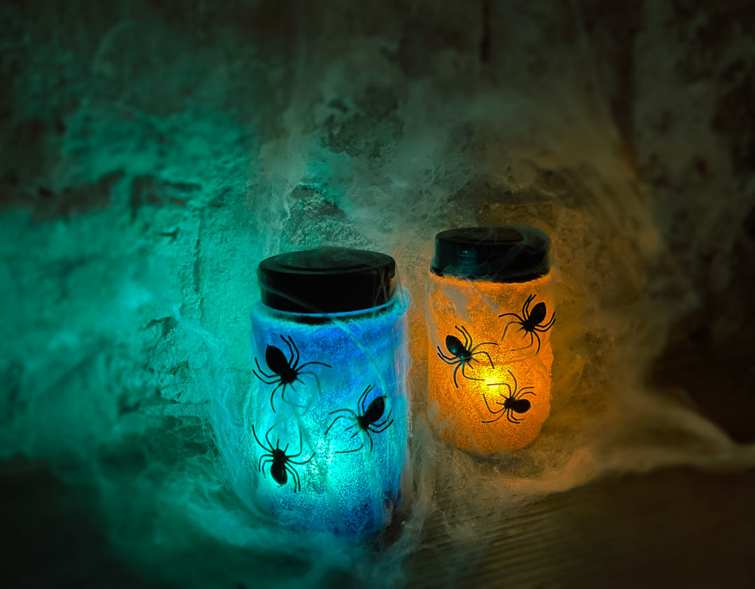 Image of two completed night light jar one is glowing blue and the other is glowing orange. 