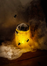 Load image into Gallery viewer, Image of a completed night light jar that is glowing orange.

