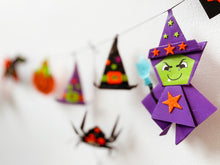 Load image into Gallery viewer, Image of the completed halloween origami garland hanging on the wall.
