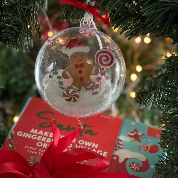 Image of a completed gingerbread village ornament hanging on a tree