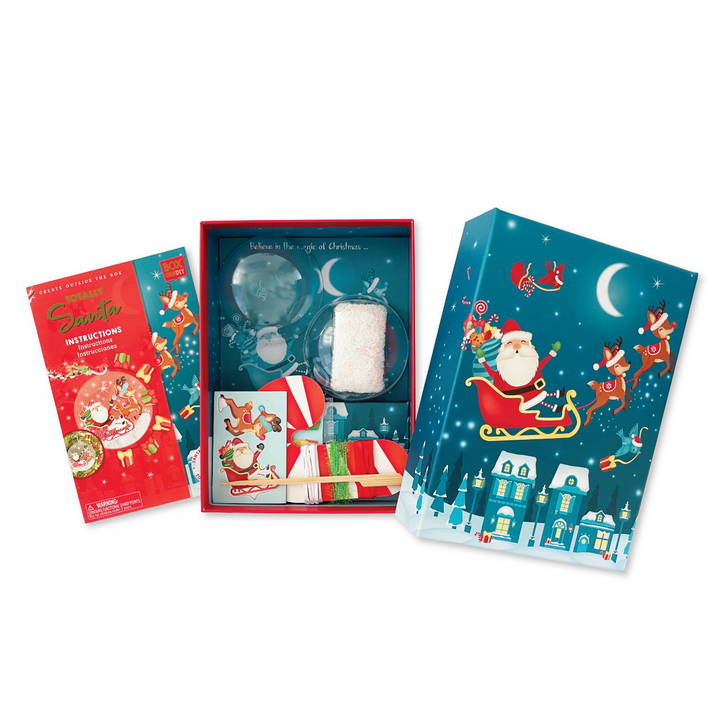 Image of Totally Santa Make Your Own  Santa Sleigh Ornament opened box to show the packaged materials inside of it. 