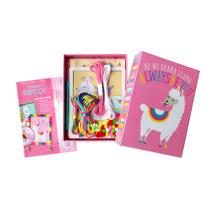 Opened boxed Image of the totally deco string & pompoms art set showing what is inside as well as a cute llama on the outside of the cardboard box. 