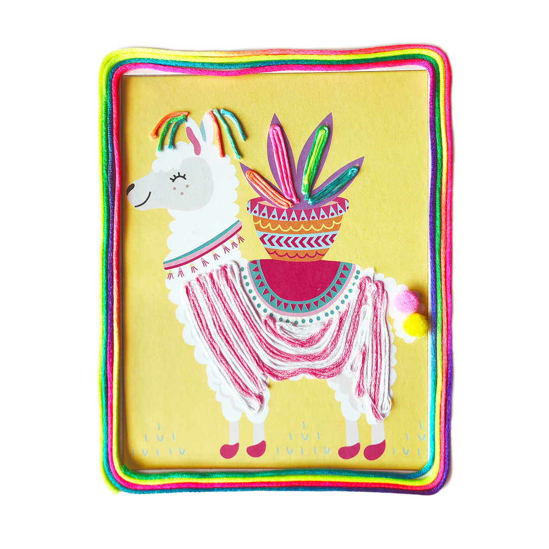 Image of a completed String and Pompoms Art Set which is a Llama decorated in colorful string and a Pompom tail. 