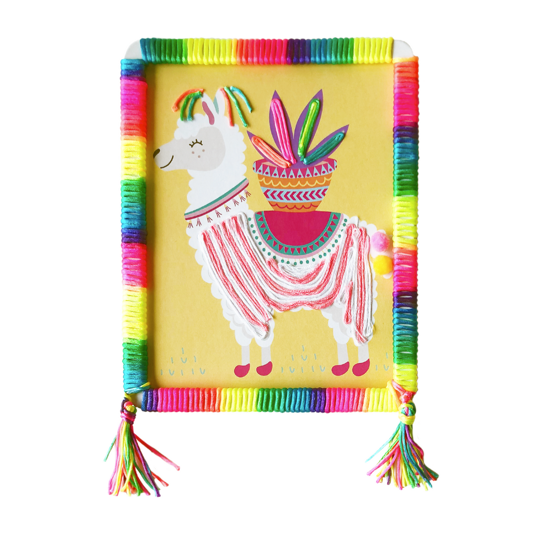 Lifestyle image of a completed Llama Totally Deco String and Pompoms Art that has rainbow string. 