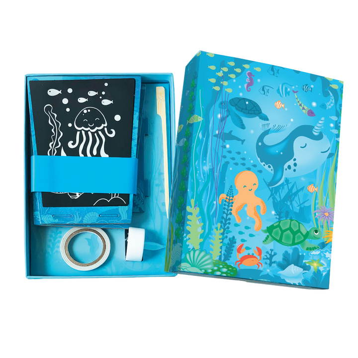 Image of the Totally Twilight Sea Life Lantern Scratch Art Set box that is opened to show the materials inside. 