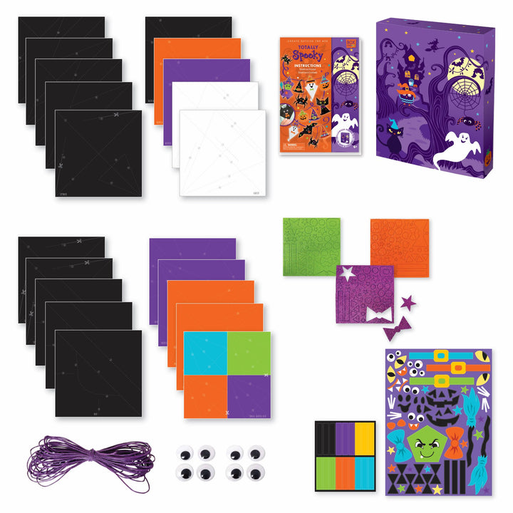 Image of the materials that come which the totally spooky origami set which Includes: 20 sheets of origami paper with pre-printed folding lines, 3 glitter sticker sheets and 2 colored sticker sheets, 4 sets ”googly” eyes, colored craft cord and instructions, all in a keepsake storage box made from recycled cardboard.